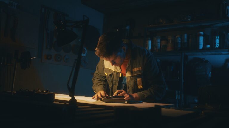 Hands of male engineer works with drawings lying sketch